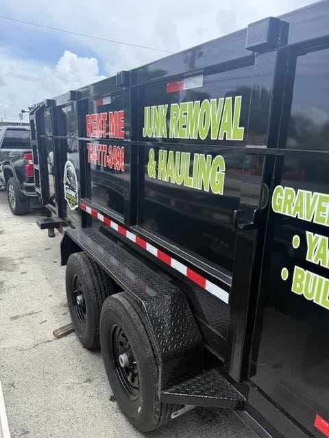 Side view of dump trailer rental with phone number 954-559-5666
